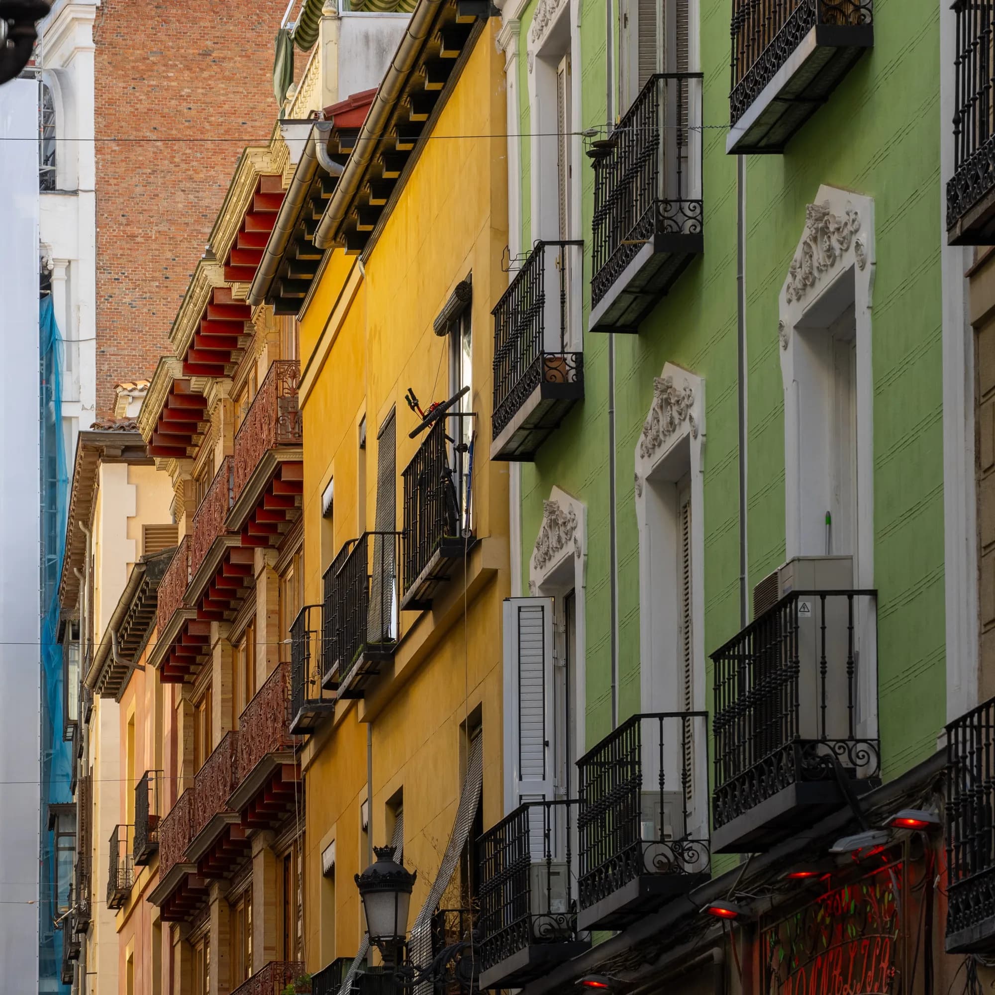 Colorful balconies stacked across a city facade